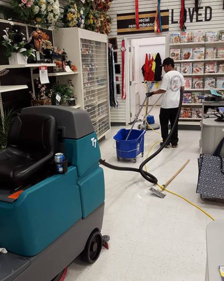 Ez Breezy employee cleaning floors of retail store